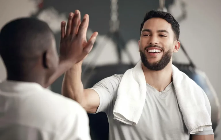 Man high-fiving another man after a workout